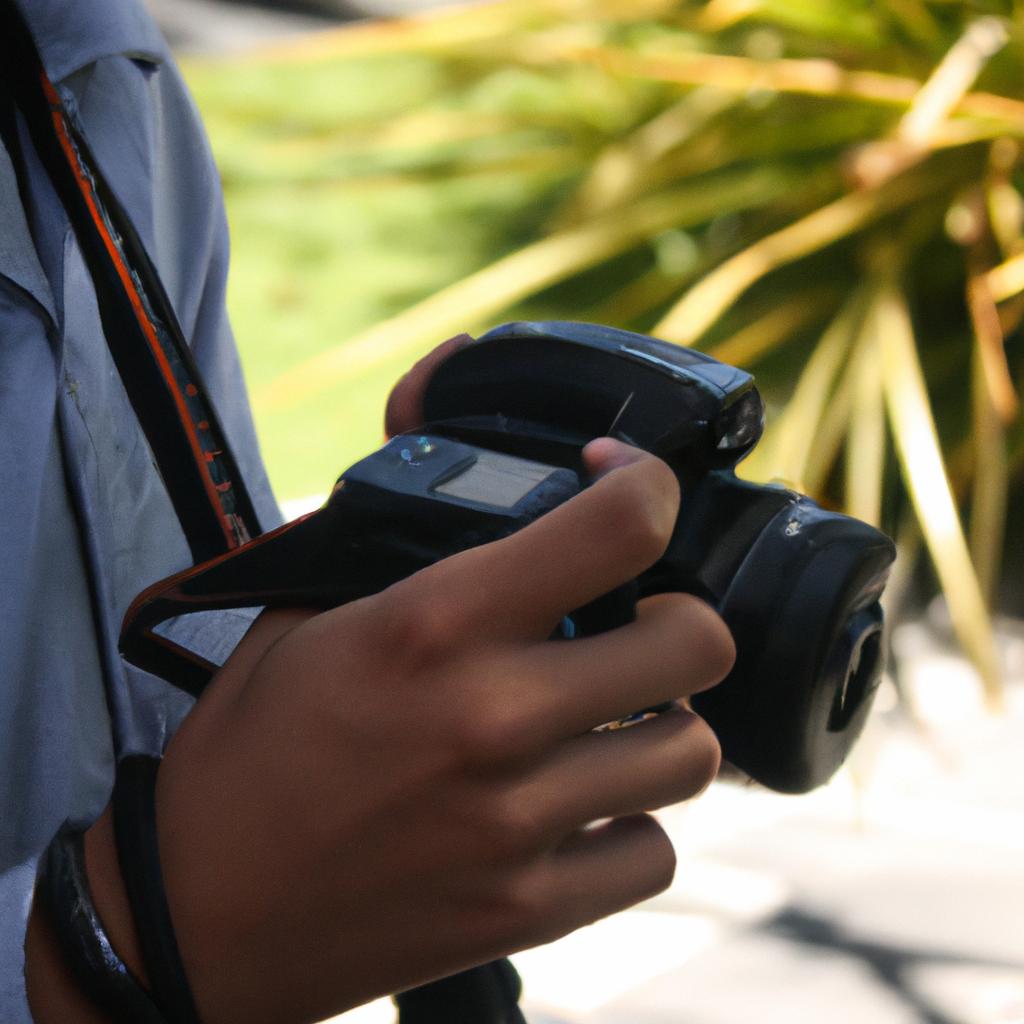 Person holding camera, adjusting settings